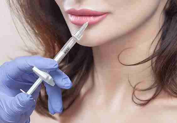 practitioner administering dermal fillers to patient
