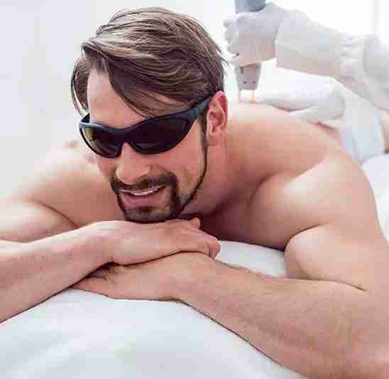 man receiving laser hair removal on back