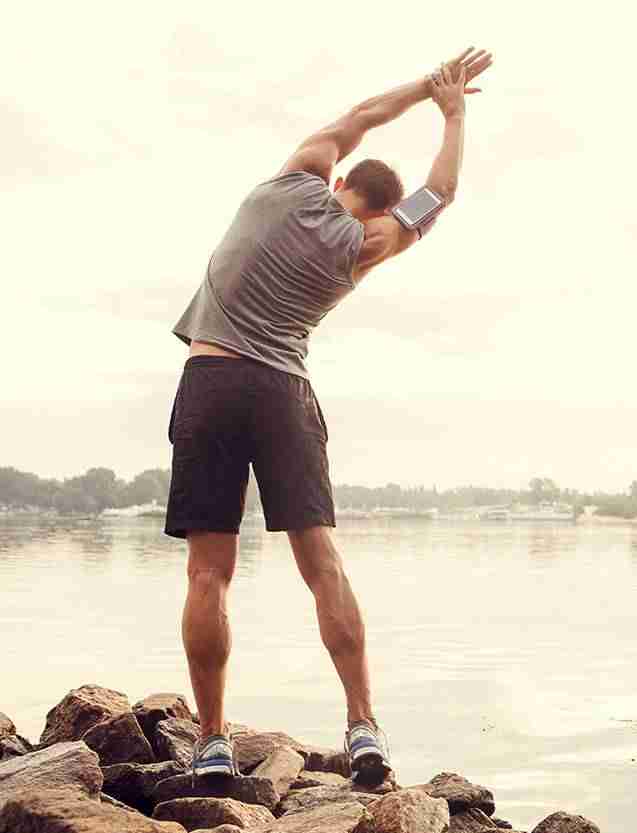 healthy young man stretching getting ready to jog